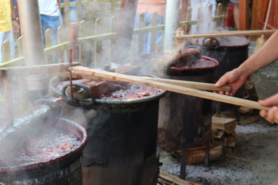 Cooking plum jam in big pots