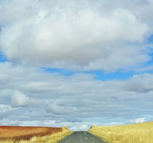 Empty road along countryside landscape