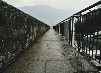 Empty footbridge against sky