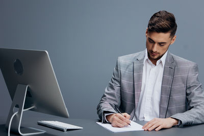 Young man using laptop at office