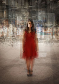 Blurred image of woman standing on footpath