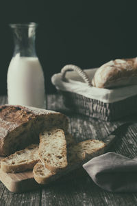 Sliced homemade artisan bread ciabatta on wooden table food blog recipe copy space breakfast idea