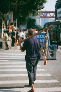 Rear view of man walking on street