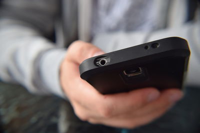 Close-up of man using mobile phone