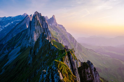 Panoramic view of snowcapped mountains against sky during sunset