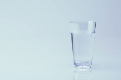 Close-up of glass of water against white background