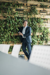 Businessman standing in green office