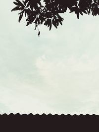 Low angle view of silhouette trees against sky
