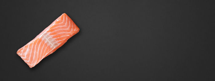 Close-up of orange fish over black background