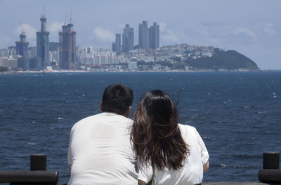 Rear view of couple looking at cityscape