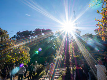 People at music concert against bright sun