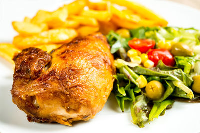 Close-up of meat and vegetables in plate