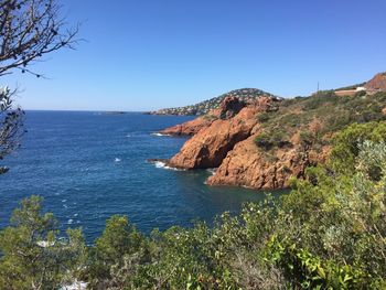 Scenic view of sea against clear blue sky