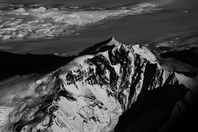 High angle view of snowcapped mountains and lake