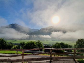 Scenic view of mountains against sky with fog