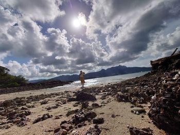 Man standing on beach against sky