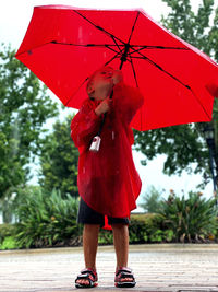 Full length of boy  with umbrella