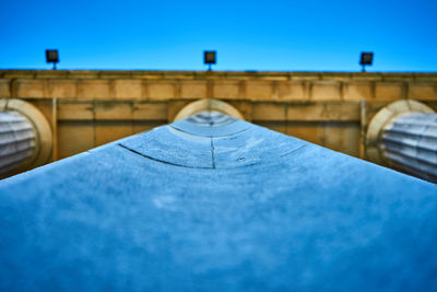 Low angle view of bridge against blue sky