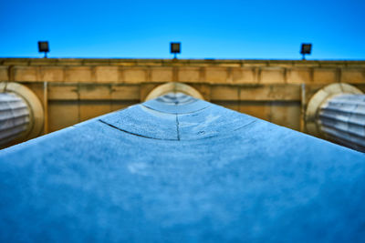 Low angle view of bridge against blue sky