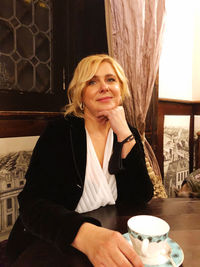 Young woman drinking coffee cup on table