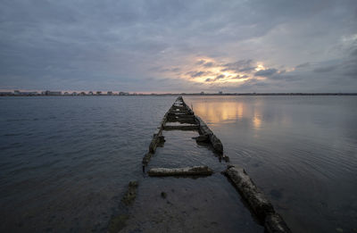 Salt lake at sunset. a path in the water that leads to the bird's habitat.