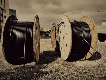 Rusty metallic structure on beach against sky