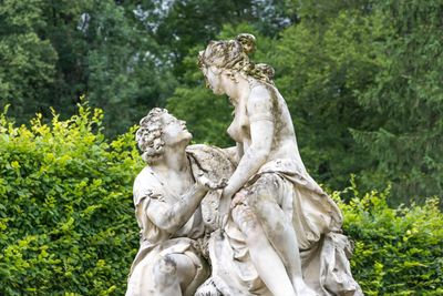 Statue against trees