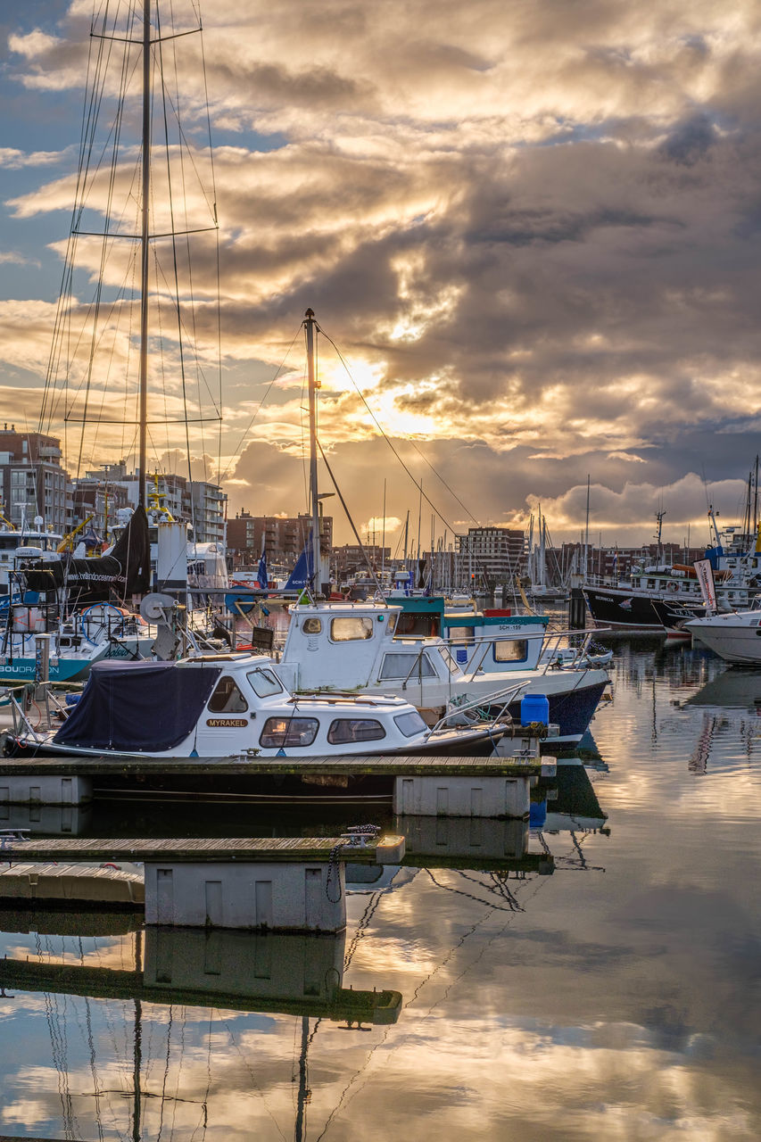 SAILBOATS MOORED AT HARBOR