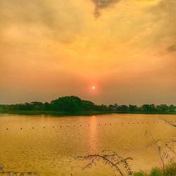 Scenic view of lake against romantic sky at sunset