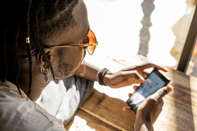 Man using mobile phone at table