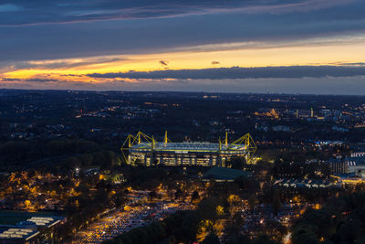 High angle view of illuminated cityscape against sky during sunset