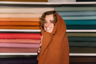 Playful fashion designer wrapped in warmth textile shop