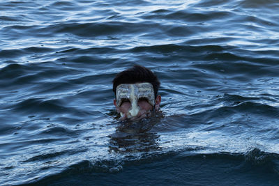 Portrait of man swimming in sea