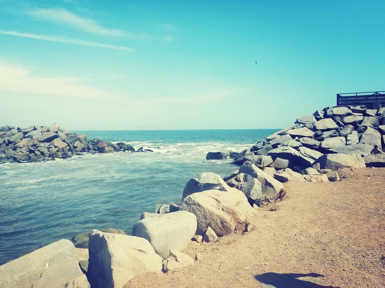 sea, water, horizon over water, rock - object, tranquil scene, tranquility, scenics, blue, beach, sky, beauty in nature, shore, nature, stone - object, rock formation, rock, day, sunlight, idyllic, outdoors