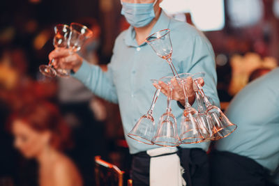 Midsection of woman drinking glass