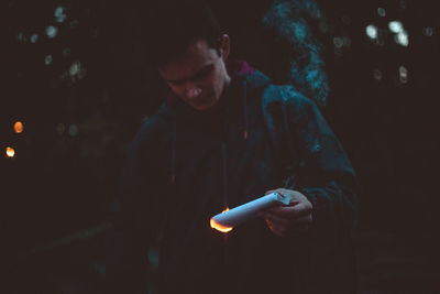 Guy holding burning paper