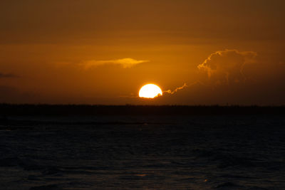 Scenic view of sea against orange sky