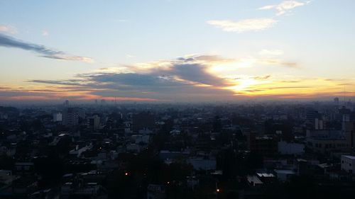 Aerial view of cityscape against sky during sunset