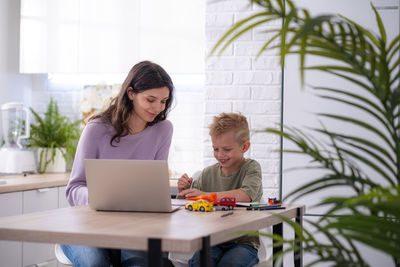 Young woman using laptop at home