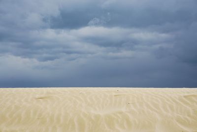 Sand dunes against sky