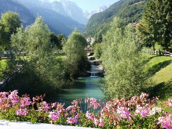 Scenic view of river by mountain against sky