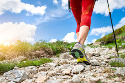 Low section of woman walking on rock