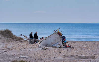 People on beach against sky