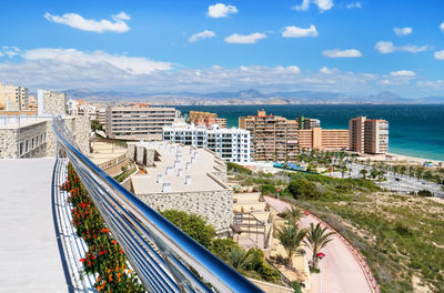 High angle view of buildings by sea against sky