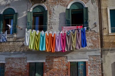 Multi colored clothes drying outside building