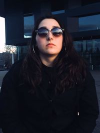 Portrait of a beautiful young woman wearing sunglasses