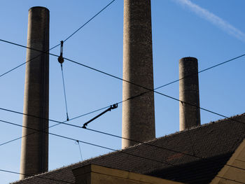 Low angle view of smoke stack against sky