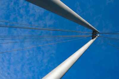 Low angle view of cables against blue sky