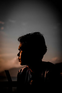 Portrait of silhouette man looking away against sky during sunset