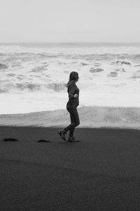 Attractive woman on empty reynisfjara beach monochrome scenic photography